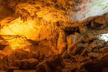 Stalactite and stalagmite formations in a limestone cave of Halong Bay, Vietnam