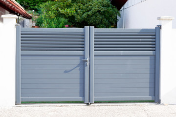 grey gate aluminum portal home door of suburbs house in street