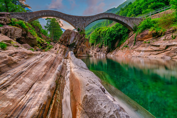 Panoramic Double arch stone bridge at Ponte dei Salti with waterfall, Lavertezzo, Verzasca, Canton Tessin, Switzerland. Travel concept Ticino.