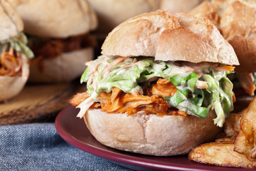 Pulled chicken sandwich with salad and bbq sauce