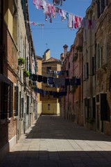 Fototapeta na wymiar Ancient road in Venice with cloths hang out to dry