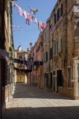 Fototapeta na wymiar Ancient road in Venice with cloths hang out to dry