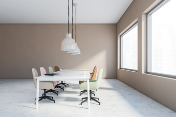 Beige meeting room with pastel chairs, side view