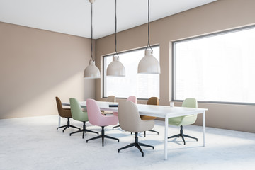 Beige meeting room corner with pastel chairs