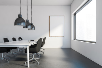 White meeting room with black chairs and poster