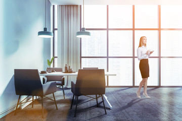 Woman in blue dining room interior