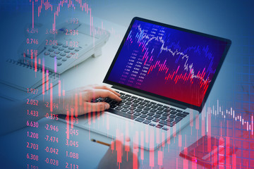 Businessman using laptop, falling graph