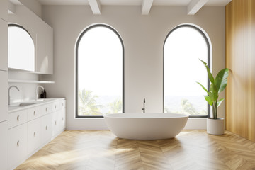 Arched white and wooden bathroom, tub and sink