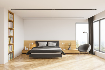 White master bedroom interior with bookcase