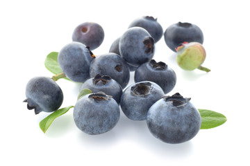 Blueberries in group with green leaves closed up isolated on white.