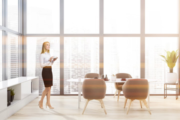 Woman in panoramic dining room with brown chairs