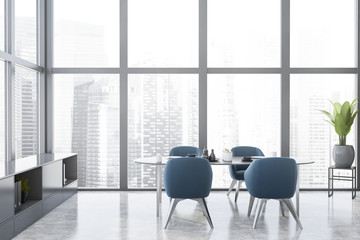 Grey dining room with blue armchairs