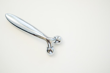 Silver metal ball roller for face massage. Facial massage tools. Beauty concept, anti-aging.