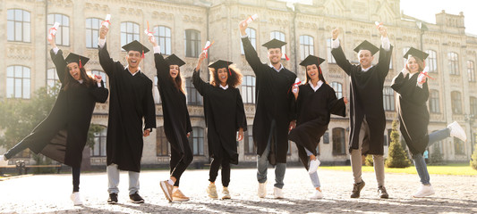 Happy students with diplomas near campus. Banner design