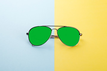 Sunglasses on blue yellow background as concept protect eyes from uv lights.