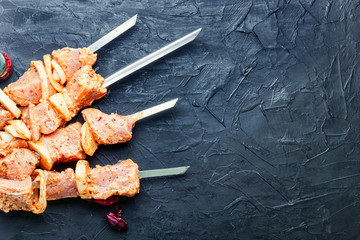 Raw meat on skewers.
