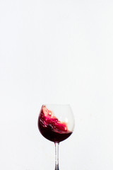 Splash red water in a wine glass with white background