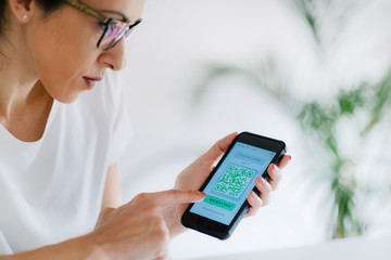 Corona Virus App. Woman Holding Smartphone with Application for Checking Health Status for COVID19.