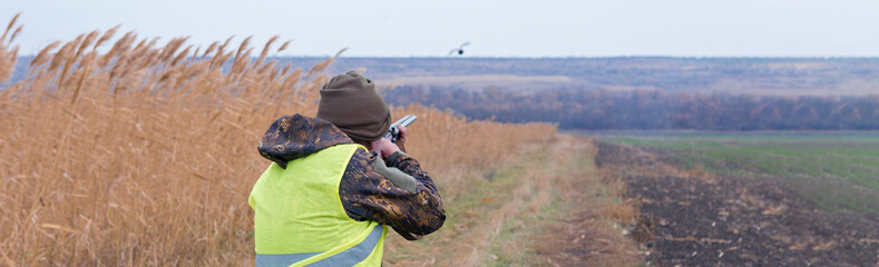 Hunters with a german drathaar and spaniel, pigeon hunting with dogs in reflective vests