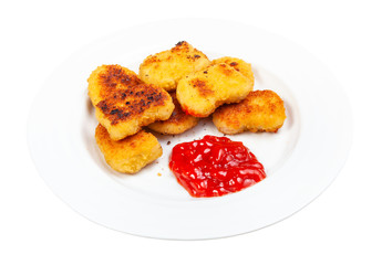 many fried chicken nuggets with tomato ketchup on white plate isolated on white background