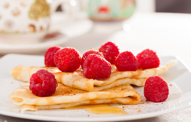 delicious  pancakes with fresh raspberries and honey