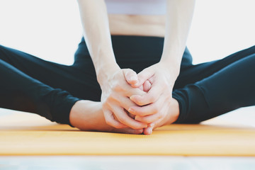 Fototapeta na wymiar young woman doing yoga on mat at home