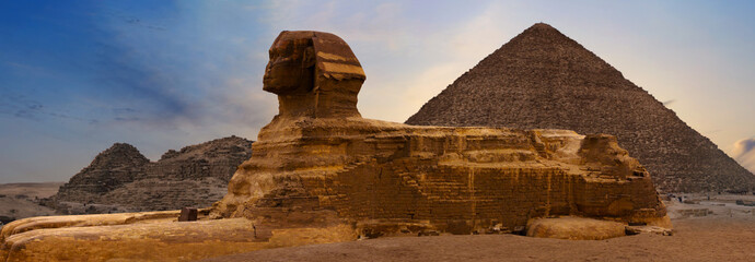 Sphinx against the backdrop of the great Egyptian pyramids. Africa, Giza Plateau.