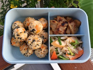 Lunch box includes Tuna Salmon Sushi ball, sausage salad and grills pork.