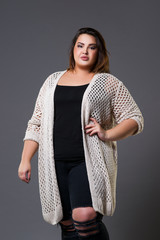 Plus size fashion model in casual clothes, fat woman on gray background