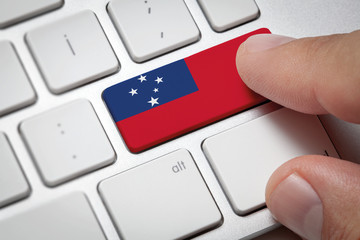 Online International Business concept: Computer key with the Samoa on it. Male hand pressing computer key with Samoa flag..