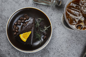 Brownie with coffee on a gray background