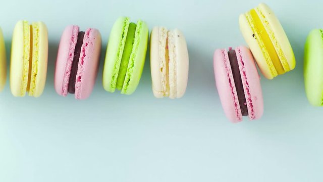 Macaroons or macaron on pastel blue surface. Close up.