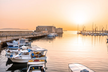 The photo of the impressive Fortress of Koules which is the Venetian castle that surrounds the harbor of Heraklion, Crete, shot during amazing sun set.