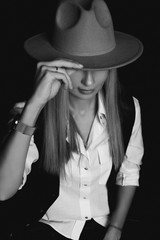 Girl covered her face with a hat.