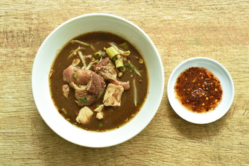 braised pork and ball with bean sprout in brown soup on bowl 