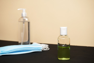Coronavirus prevention medical surgical masks and hand sanitizer gel for hand hygiene corona virus protection. Healthcare and medical concept.