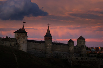 Sunset view on the castle in Kamianets-Podilskyi in spring.