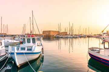Fototapeta premium The photo of the impressive Fortress of Koules which is the Venetian castle that surrounds the harbor of Heraklion, Crete, shot during amazing sun set.