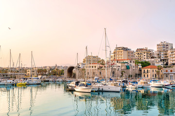 Fototapeta na wymiar Photo of Heraklion in the early morning during sun rise, close-up picture of to the old part of the town/city with its antient buildings and marina