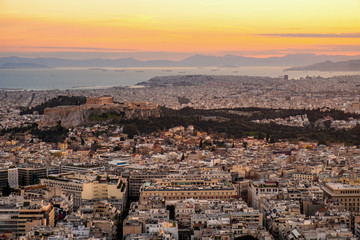 Panoramic sunset view of Athens, Greece, with Acropolis hill and Piraeus port at Saronic Gulf of...