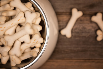 Dog biscuits in a bowl, top view.