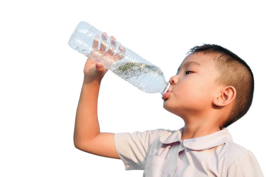 Portrait image of child 5-6 years old. Happy Asian child student boy drinking some water by a plastic bottle. After finished from exercise. Healthy kid. Summer season. On white background isolated.