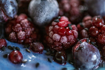 Close up of frozen berries and a blue cream. Frozen summer fruit macro.