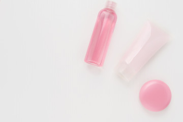 Cosmetics for beauty and skin care, makeup. Foam cleansing, moisturizing, nourishing from acne and wrinkles, lip balm and pink tonic on a white background