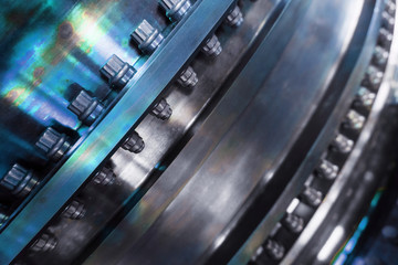 A detailed view of the gas turbine engine for generating electricity, shows the bolt connection design and the pipe laying outside. © Alexander