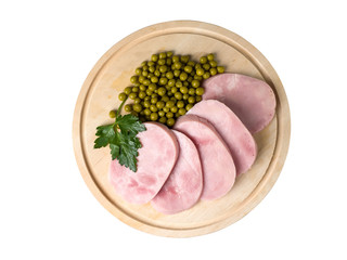 Ham sliced on a blackboard. Near green peas and parsley
