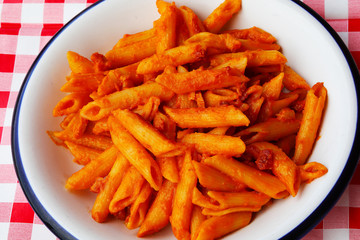 heaped plate of pasta with tomato sauce called Mezze Penne in It