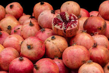 fresh red pomegranates in an open market
