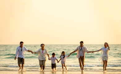 Group of Happy multi generation Asian family relax and having fun together on tropical beach in summertime. Smiling big family parents with child boy and girl enjoy in summer lifestyle travel vacation © CandyRetriever 
