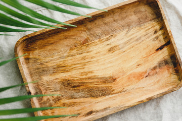Wooden tray is made from mango tree on a linen cloth decorated palm leaf. Eco friendly and summer...